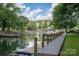 Scenic waterfront view with a private dock, mature trees, and serene water reflecting the sky at 1934 Hickory Hills Dr, Denver, NC 28037