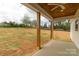 Covered back porch view with natural wood beams and view of yard at 2657 Polo Ln, Maiden, NC 28650