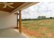 Covered back porch view with natural wood beams and view of yard at 2657 Polo Ln, Maiden, NC 28650