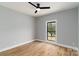 This bedroom offers natural light from the window, hardwood floors, and modern ceiling fan at 2657 Polo Ln, Maiden, NC 28650