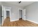 Bright bedroom featuring hardwood floors, and entry to closet with installed shelving at 2657 Polo Ln, Maiden, NC 28650