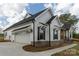 Well-maintained home featuring white siding, black accents, and a convenient attached garage at 2657 Polo Ln, Maiden, NC 28650