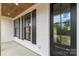Covered front porch featuring wood ceiling, black door, and windows with black shutters at 2657 Polo Ln, Maiden, NC 28650