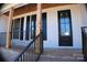 Charming front porch of a new home with wooden beams, brick base, and black framed windows at 2657 Polo Ln, Maiden, NC 28650