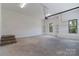 Spacious garage with concrete floors, shelving units, steps, and a window overlooking greenery at 2657 Polo Ln, Maiden, NC 28650