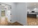 Hallway with hardwood floors leading to bright kitchen and bedroom at 2657 Polo Ln, Maiden, NC 28650