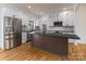 Bright kitchen with stainless steel appliances, granite countertops, and white cabinets, creating a modern cooking space at 2657 Polo Ln, Maiden, NC 28650