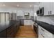 Spacious kitchen features stainless appliances, granite counters, and white cabinets; a modern culinary space at 2657 Polo Ln, Maiden, NC 28650