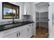 Close-up of a bright kitchen featuring granite counters, stainless steel sink and a walk in pantry at 2657 Polo Ln, Maiden, NC 28650