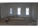 Unfinished living room with hardwood floors and three windows at 2657 Polo Ln, Maiden, NC 28650