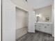 Bright bathroom with double vanity, modern fixtures, and a linen closet, offering ample storage space at 7510 Water Oak Ln, Monroe, NC 28110