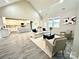 Open-concept living room showcasing hardwood floors and a seamless flow into the kitchen at 7510 Water Oak Ln, Monroe, NC 28110