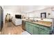 Open concept kitchen with green cabinets, granite countertops, and a large sink at 8003 Belmont Stables Dr, Charlotte, NC 28216