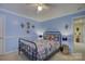 Light and airy bedroom with a metal bed frame and ocean decor at 8502 Sagekirk Ct, Charlotte, NC 28278