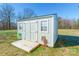 Light gray storage shed with double doors and deck at 910 Island Ford Rd, Maiden, NC 28650