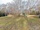 Large backyard with playset and wooded area at 10035 Little Creek Rd, Mint Hill, NC 28227