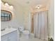 Clean bathroom with shower/tub combo, gray vanity, and updated fixtures at 10035 Little Creek Rd, Mint Hill, NC 28227