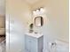 Simple bathroom with gray vanity and a framed mirror at 10035 Little Creek Rd, Mint Hill, NC 28227