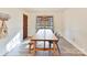 Bright dining room with a long wooden table and wicker pendant light at 10035 Little Creek Rd, Mint Hill, NC 28227