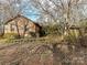 Brick ranch house with a covered porch, surrounded by trees at 10035 Little Creek Rd, Mint Hill, NC 28227