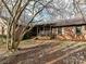 Brick ranch house with covered porch and mature trees in the yard at 10035 Little Creek Rd, Mint Hill, NC 28227