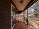 Covered porch with tiled flooring, wooden swing, and glass door at 10035 Little Creek Rd, Mint Hill, NC 28227