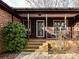 Brick steps leading to a covered porch with a glass front door at 10035 Little Creek Rd, Mint Hill, NC 28227