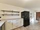 Modern kitchen with white cabinets, black appliances, and concrete countertops at 10035 Little Creek Rd, Mint Hill, NC 28227