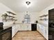 Modern kitchen with white cabinets, L-shaped counters, and stainless steel appliances at 10035 Little Creek Rd, Mint Hill, NC 28227