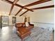 Living room with hardwood floors, exposed beams, and a fireplace at 10035 Little Creek Rd, Mint Hill, NC 28227