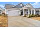 One story house with gray siding, two-car garage, and front porch at 111 N Shayna Rd, Troutman, NC 28166