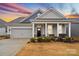 Gray siding one-story house with front porch and two-car garage at 111 N Shayna Rd, Troutman, NC 28166