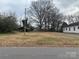 A vacant lot ready for development featuring lush trees and an overcast sky at 1319 7Th St, Statesville, NC 28677