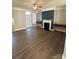 Living room with fireplace, built-in shelving, and hardwood floors at 14243 Richmond Park Ave, Charlotte, NC 28277