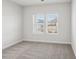 Bright bedroom with neutral walls and carpeting, featuring two large windows at 1535 Harper Landing Blvd, Stanley, NC 28164