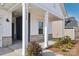 Covered front porch with brick facade and landscaping at 1535 Harper Landing Blvd, Stanley, NC 28164