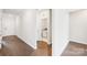 Bright hallway with hardwood floors and access to laundry at 1535 Harper Landing Blvd, Stanley, NC 28164