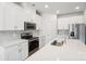 Modern kitchen with white cabinets, stainless steel appliances and island at 1535 Harper Landing Blvd, Stanley, NC 28164