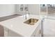 Modern kitchen island with quartz countertop and stainless steel sink at 1535 Harper Landing Blvd, Stanley, NC 28164