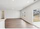 Bright living room with hardwood floors and sliding glass doors at 1535 Harper Landing Blvd, Stanley, NC 28164