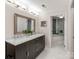 Modern bathroom with double vanity, marble countertop, and a large mirror at 18015 Kings Point Dr # F, Cornelius, NC 28031