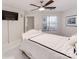 Bedroom with a white upholstered bed, ceiling fan, and a view at 18015 Kings Point Dr # F, Cornelius, NC 28031