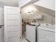 Convenient laundry room with washer, dryer, and storage shelves at 18015 Kings Point Dr # F, Cornelius, NC 28031