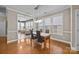 Spacious dining area with hardwood floors and a view into the sunroom at 18119 Coulter Pkwy, Cornelius, NC 28031