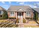 Charming brick home with manicured landscaping, gray shutters, and a welcoming front porch at 18119 Coulter Pkwy, Cornelius, NC 28031