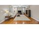 Bright living room with hardwood floors, a comfortable sofa, and large windows at 18119 Coulter Pkwy, Cornelius, NC 28031