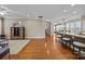 Open-concept living area featuring hardwood floors, a breakfast bar, and access to another room at 18119 Coulter Pkwy, Cornelius, NC 28031