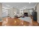 Spacious living room featuring hardwood floors, a plush sofa, and plenty of natural light at 18119 Coulter Pkwy, Cornelius, NC 28031