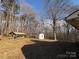 Backyard featuring a wooden shelter and a storage shed nestled in a wooded lot at 1830 Light Brigade Dr, Matthews, NC 28105