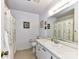 Well-lit bathroom featuring a vanity with mirror, toilet, and shower/tub with floral curtain at 1830 Light Brigade Dr, Matthews, NC 28105